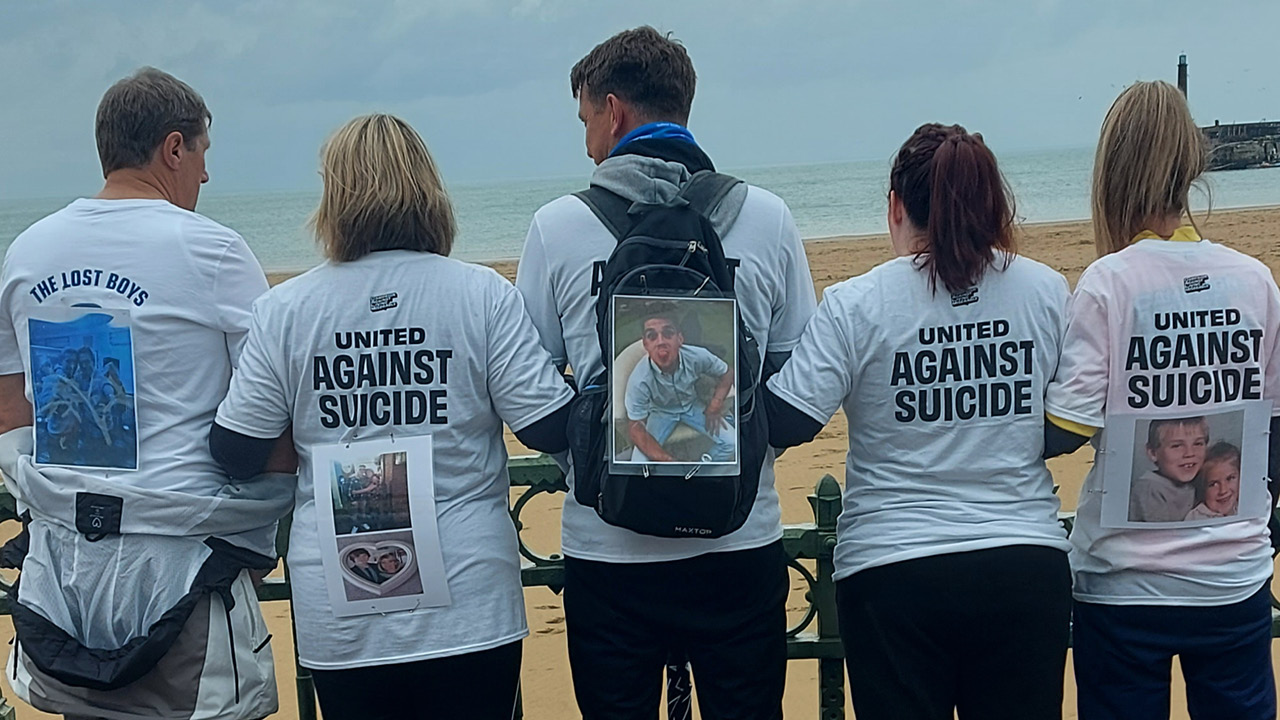 Image of five Lost Hours Walkers, showing photos of loved ones pinned onto their backs